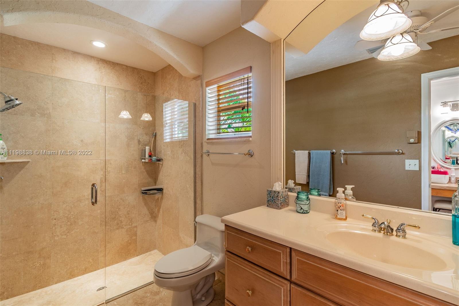 3015 Dunlin Road Delray Beach, FL 33444 - Photo 42 of 47 a bathroom with a sink a toilet and shower