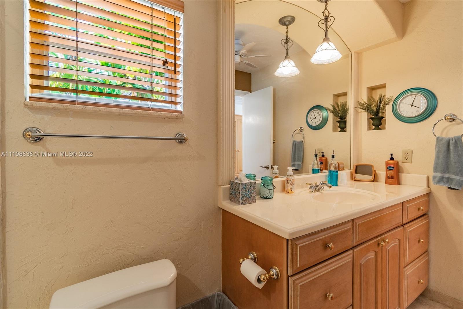 3015 Dunlin Road Delray Beach, FL 33444 - Photo 43 of 47 a bathroom with a sink vanity mirror and toilet
