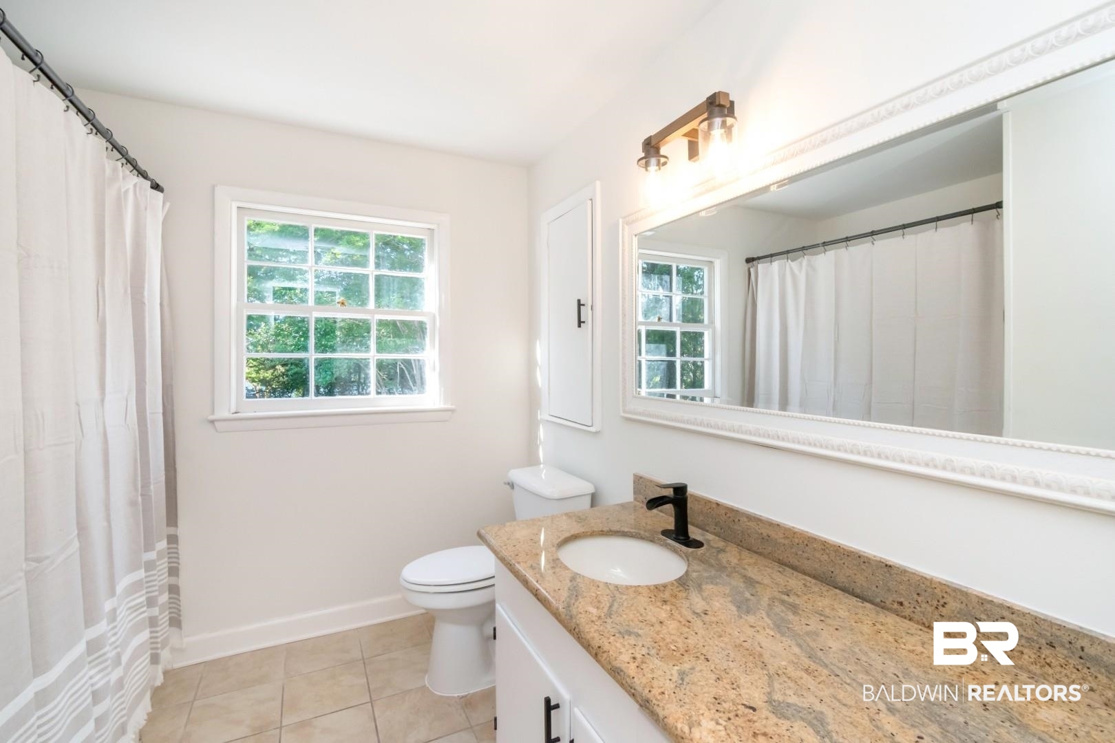 115 Pineridge Road Daphne, AL 36526 - Photo 25 of 34 Full bathroom featuring baseboards, tile patterned floors, vanity, and toilet