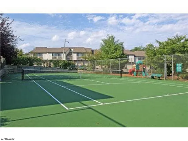 a view of a workspace with furniture and a flat screen tv