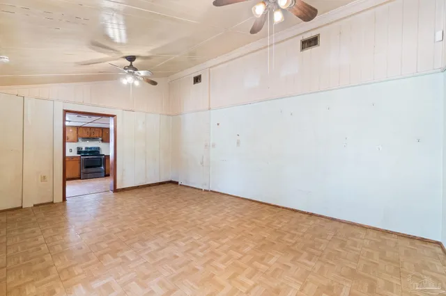a view of an empty room with a ceiling fan