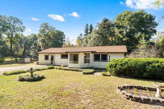 a front view of a house with a yard covered with green space