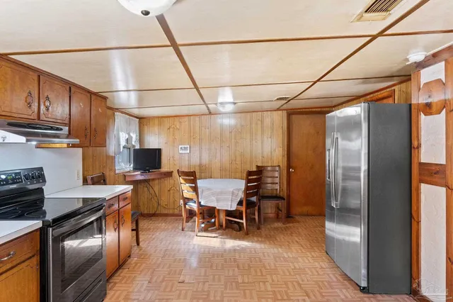 a kitchen with a sink appliances and cabinets