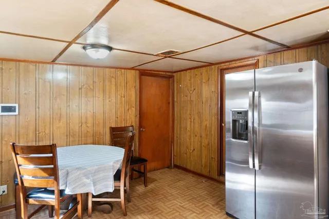 a dining room with a table and chairs