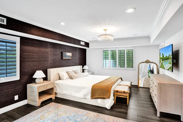 a bedroom with furniture and a large window