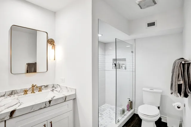 a bathroom with a sink toilet and shower