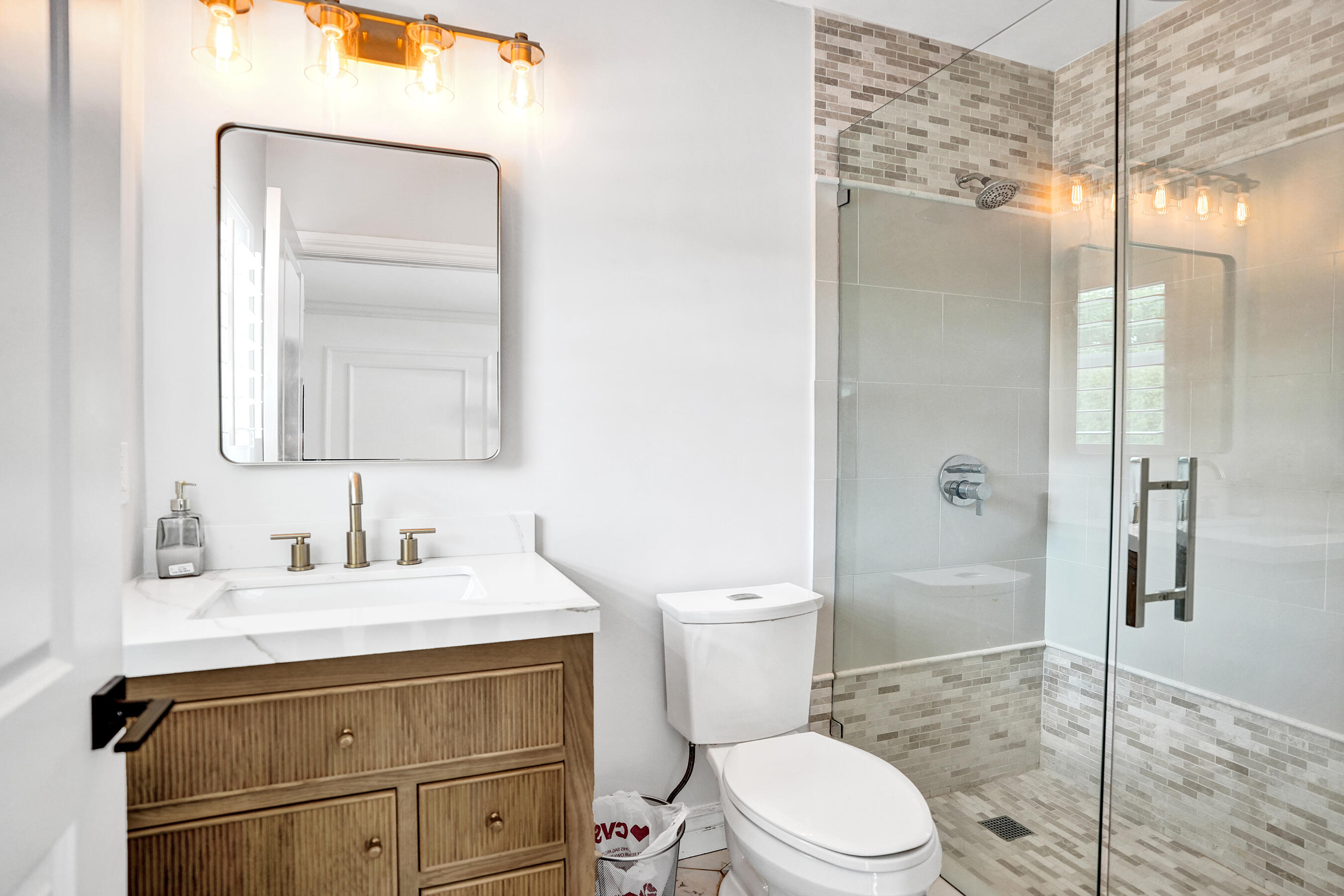 915 North Swinton Avenue Delray Beach, FL 33444 - Photo 15 of 23 a bathroom with a sink a toilet and shower