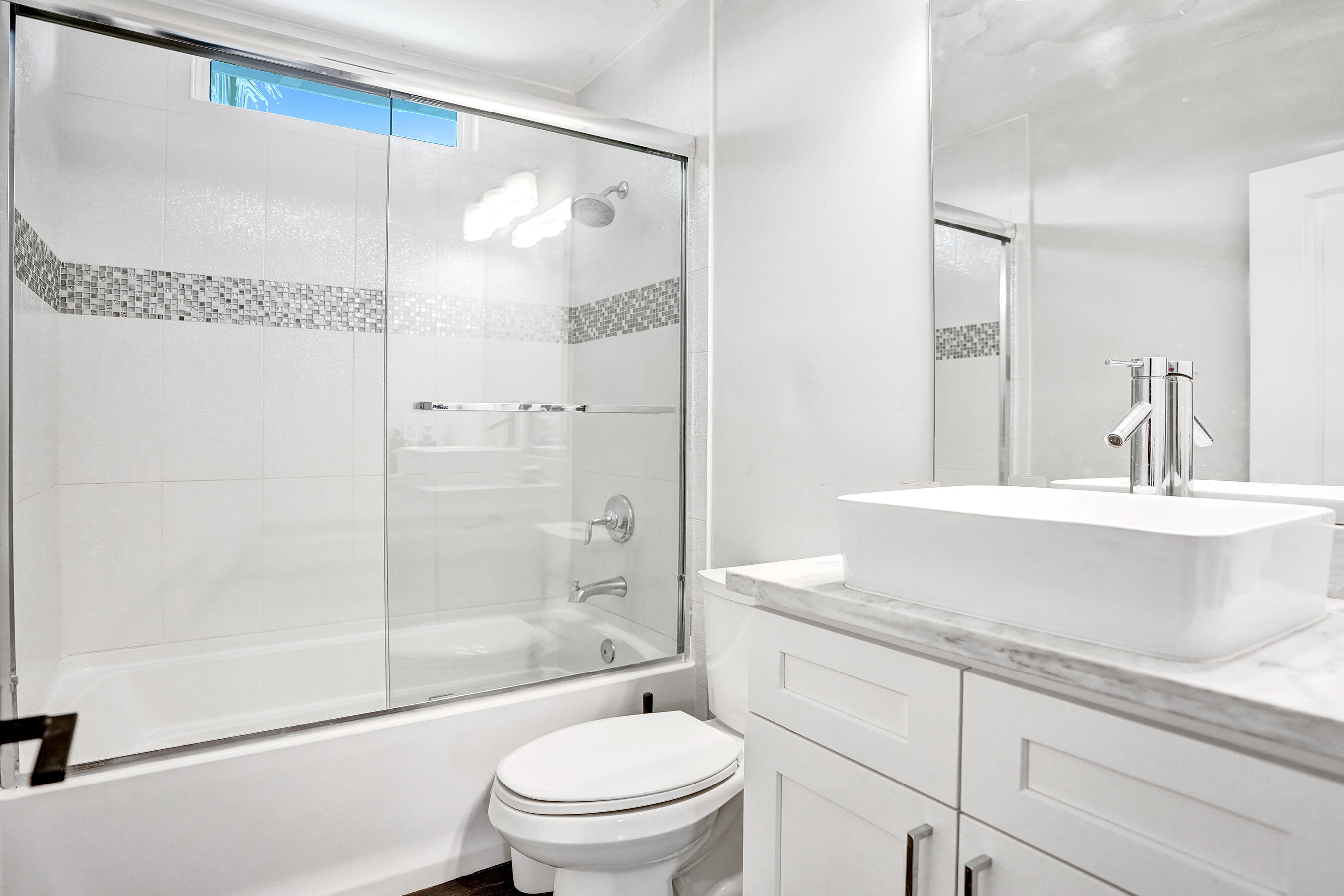 915 North Swinton Avenue Delray Beach, FL 33444 - Photo 17 of 23 a bathroom with a granite countertop sink a toilet and shower
