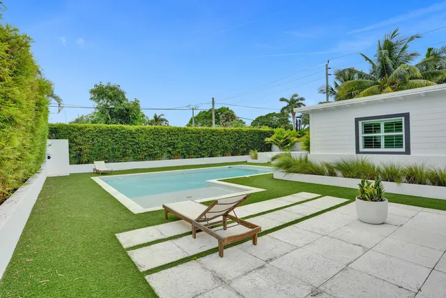 a view of a backyard with plants and a patio