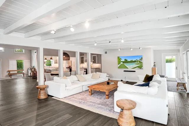 a living room with fireplace furniture and a wooden floor