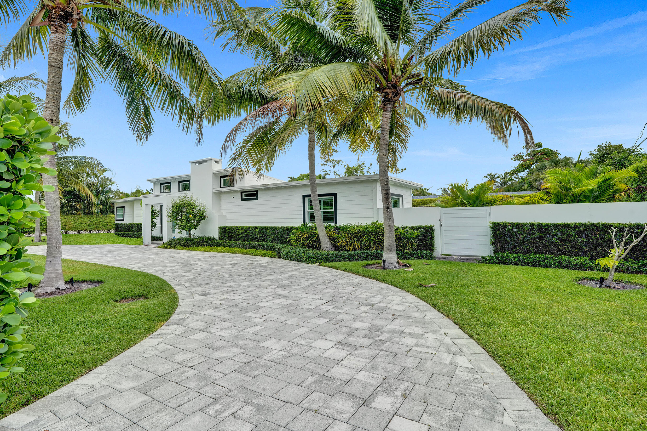 915 North Swinton Avenue Delray Beach, FL 33444 - Photo 8 of 23 a front view of a house with garden