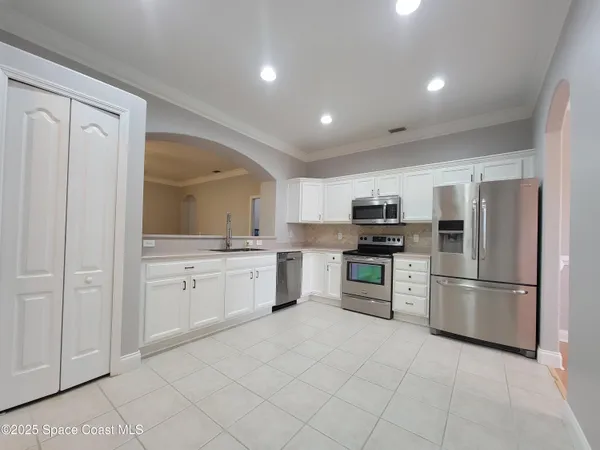 a kitchen with a refrigerator sink and stove top oven