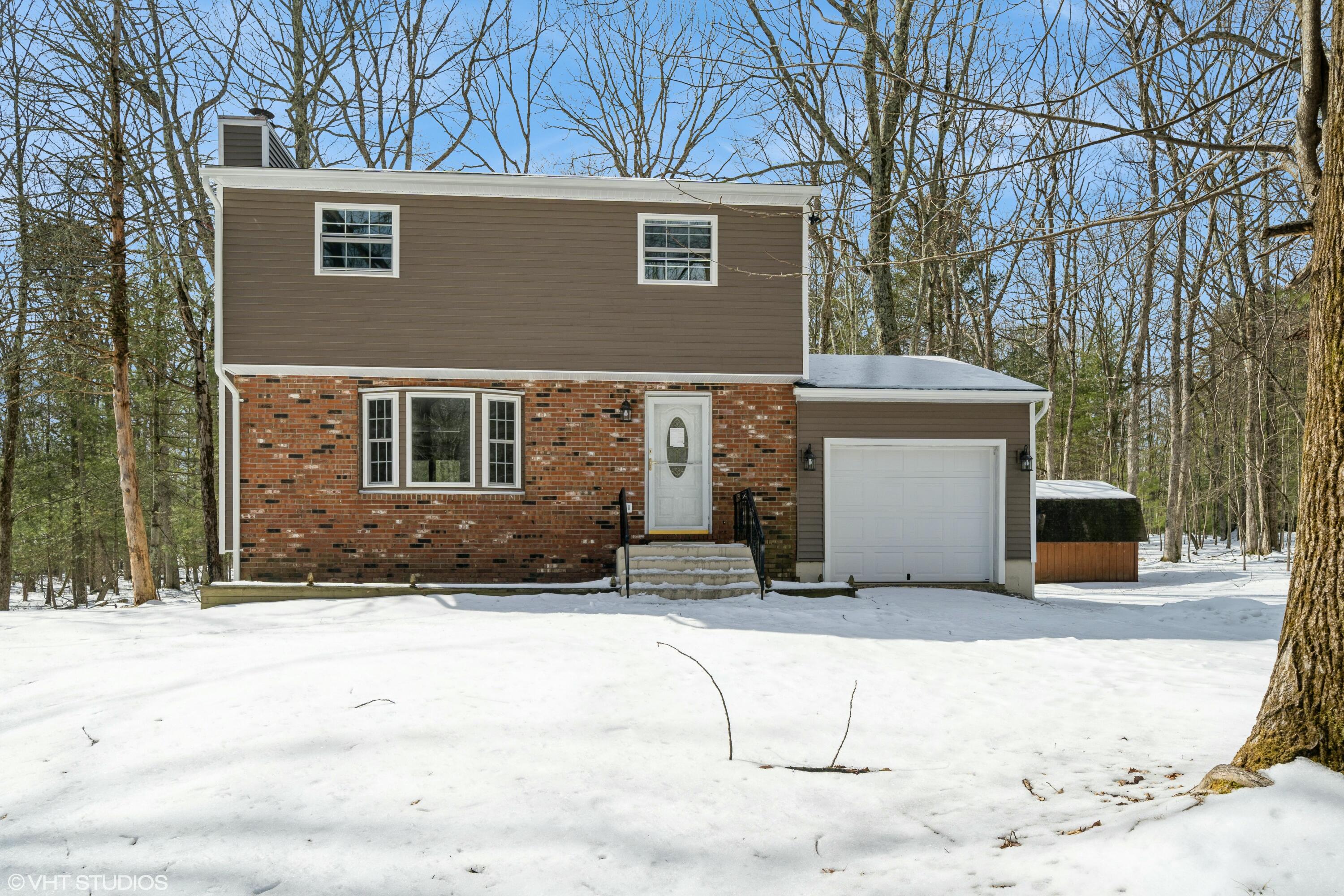 a view of house with yard covered in snow