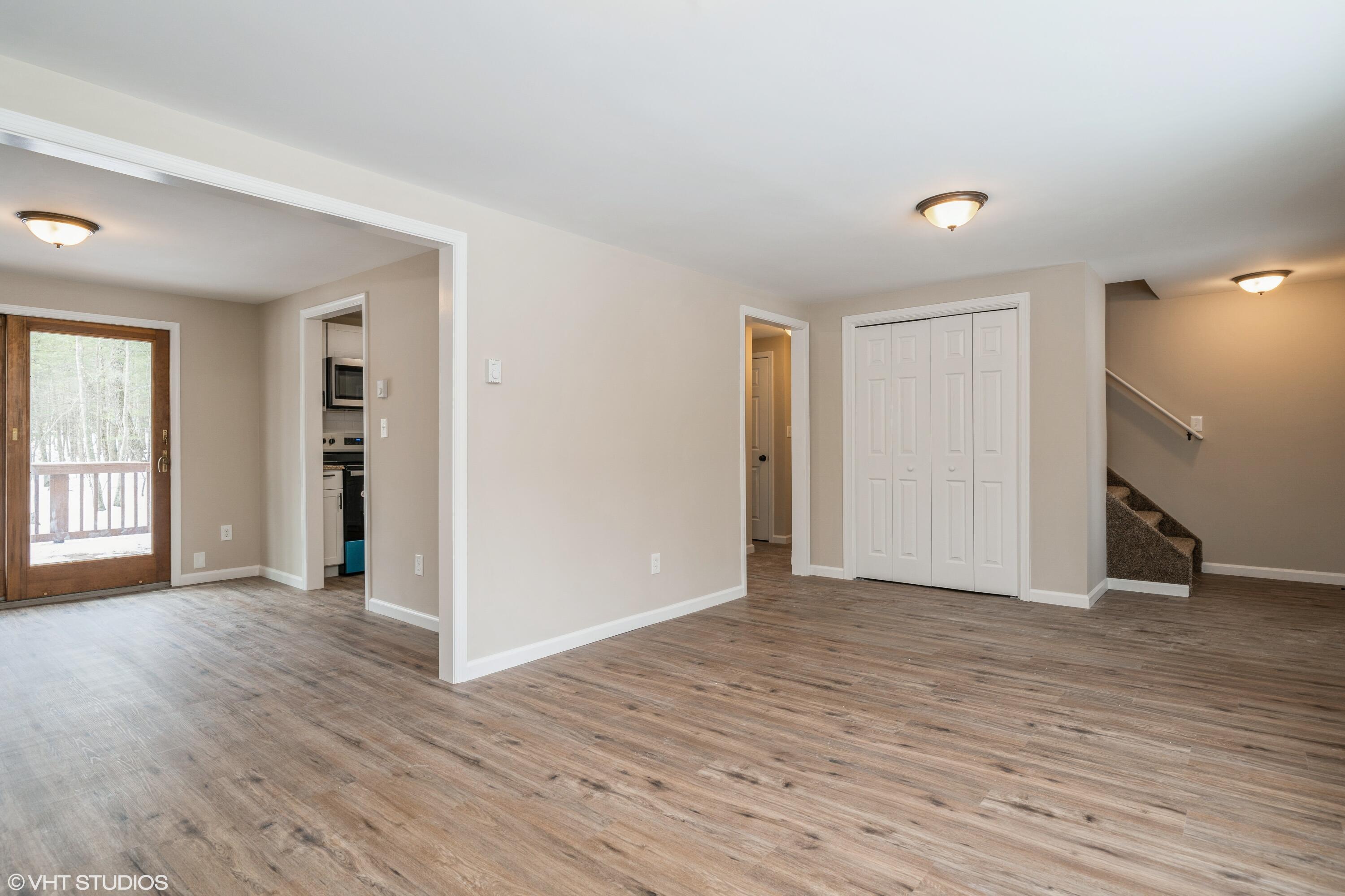 122 Fox Road Dingmans Ferry, PA 18328 - Photo 5 of 15 an empty room with wooden floor and windows