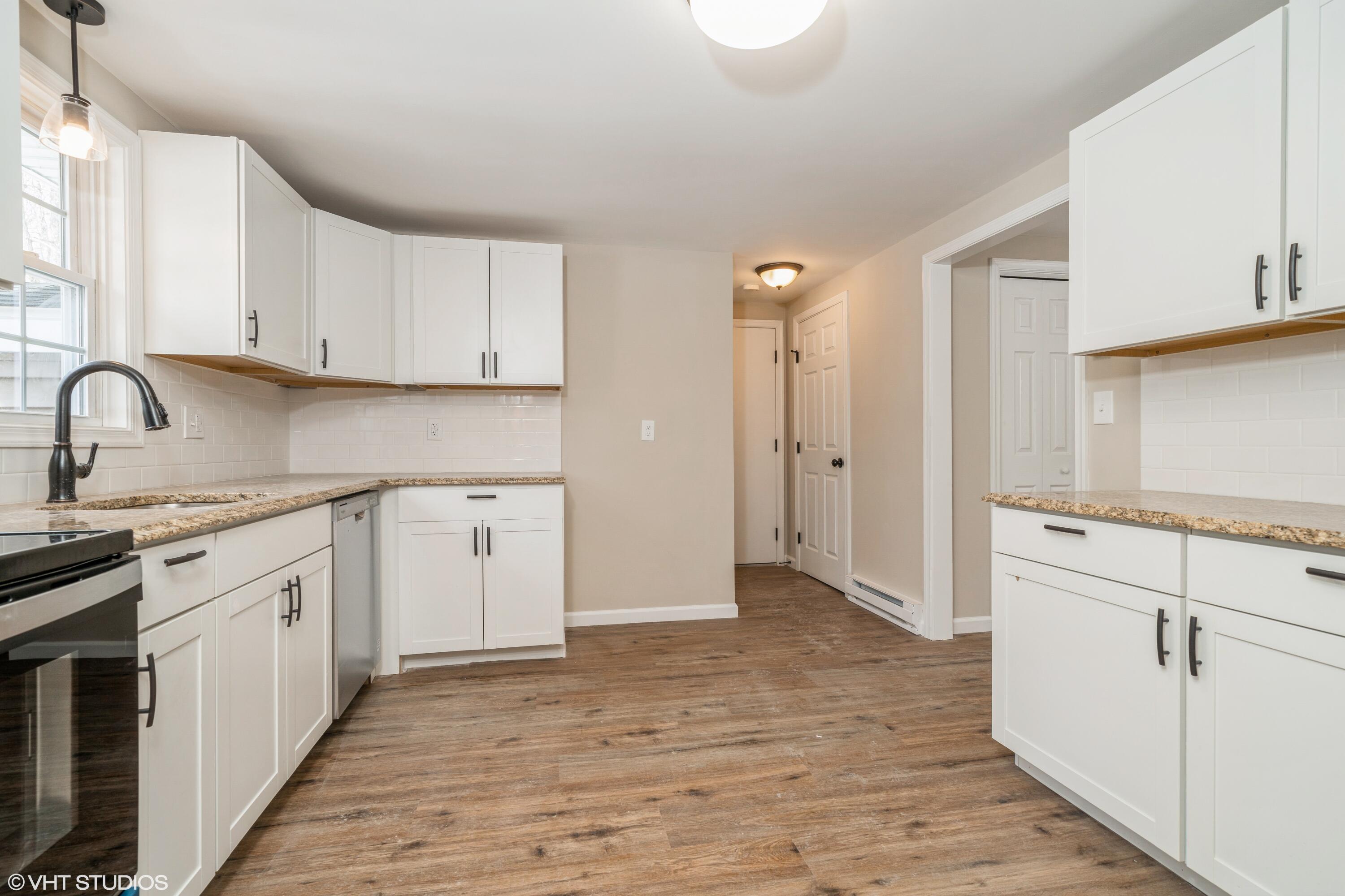 122 Fox Road Dingmans Ferry, PA 18328 - Photo 7 of 15 a kitchen with granite countertop white cabinets and white appliances
