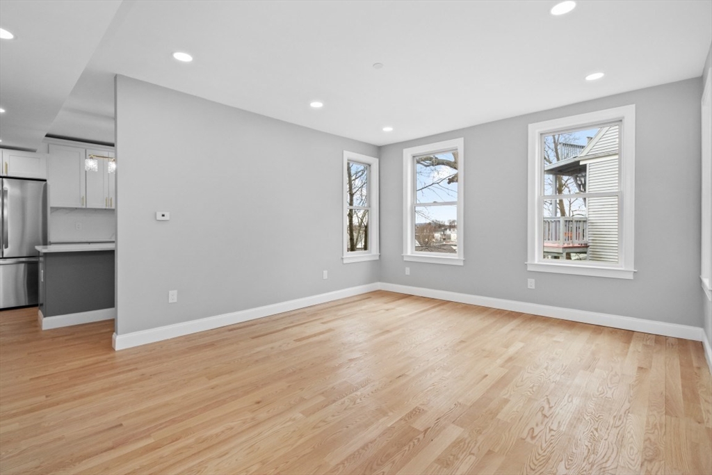 66 Stanley Street, Unit 2 Boston, MA 02125 - Photo 11 of 21 wooden floor in an empty room with a window