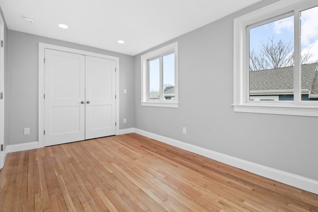 66 Stanley Street, Unit 2 Boston, MA 02125 - Photo 12 of 21 a view of an empty room with wooden floor and a window