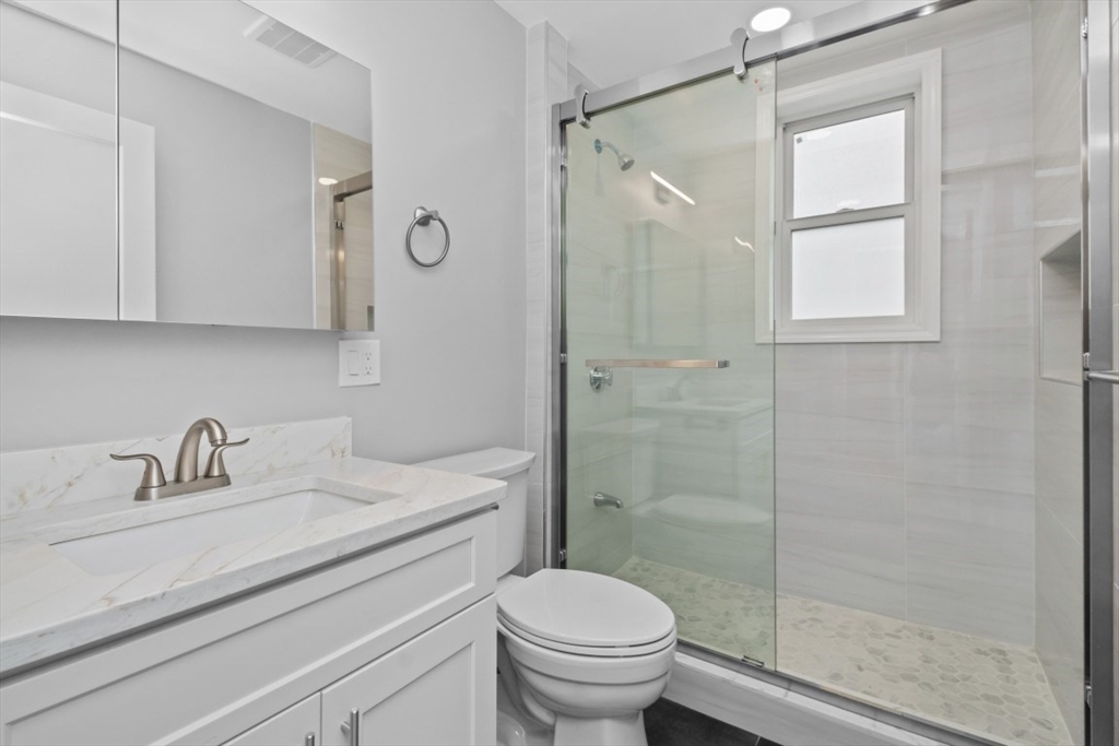 66 Stanley Street, Unit 2 Boston, MA 02125 - Photo 6 of 21 a bathroom with a sink a toilet and shower