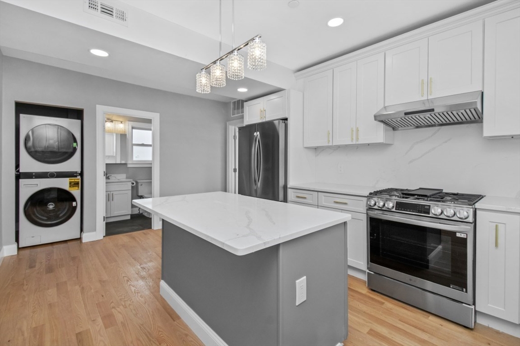 66 Stanley Street, Unit 2 Boston, MA 02125 - Photo 8 of 21 a kitchen with a stove a microwave and cabinets
