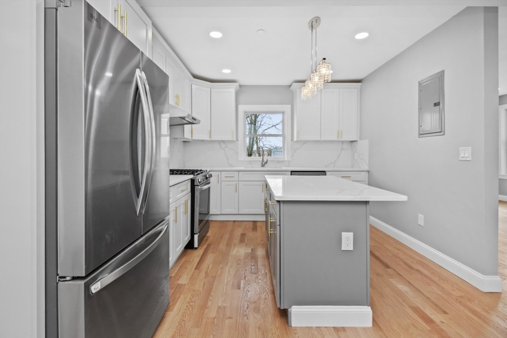 66 Stanley Street, Unit 2 Boston, MA 02125 - Photo 10 of 21 a kitchen with stainless steel appliances a refrigerator sink and microwave