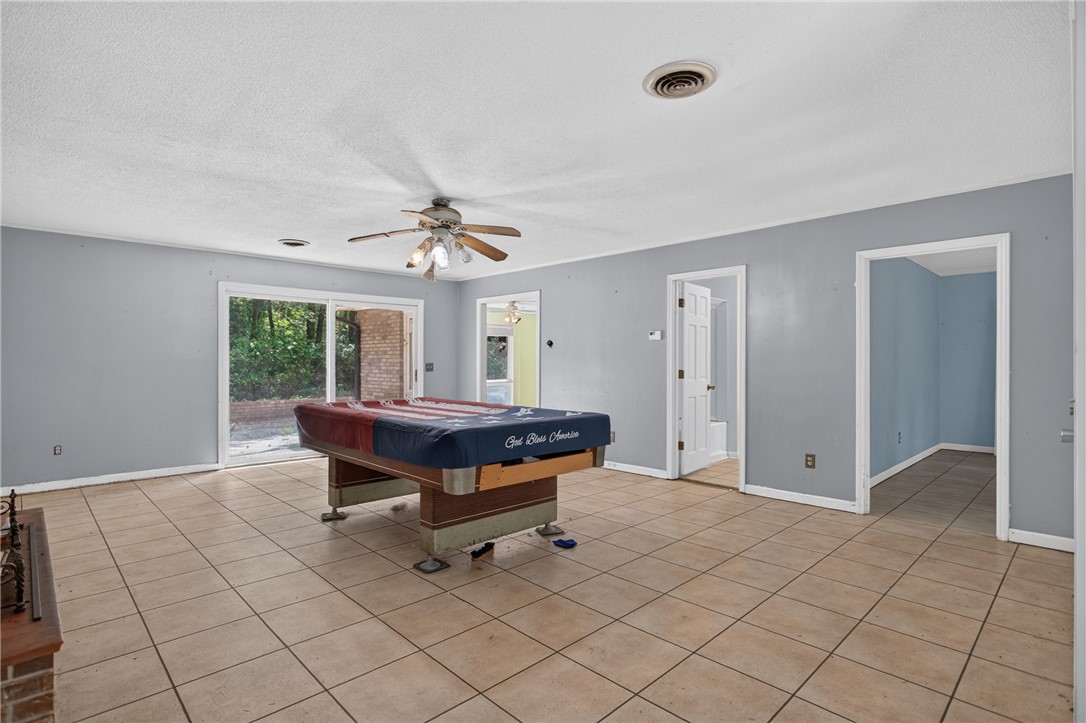 123 Robin Road Westminster, SC 29693 - Photo 14 of 50 A spacious recreation room with durable tile flooring and direct outdoor access.
