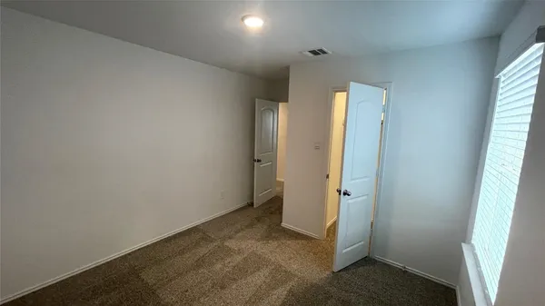 a room with a sink a microwave a refrigerator and cabinets