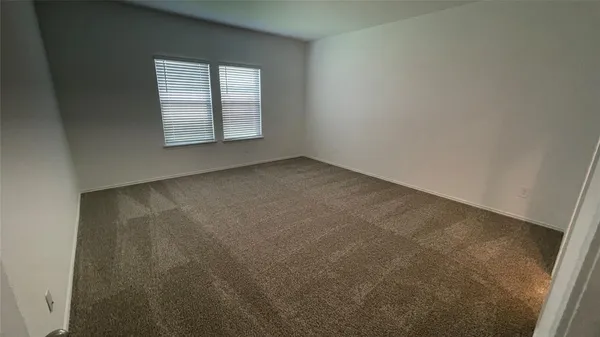 a view of an empty room with windows