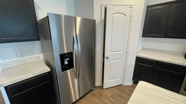 a kitchen with wooden cabinets and a stove top oven