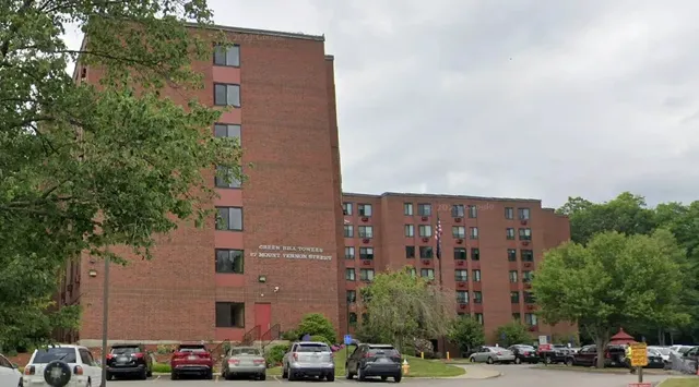 a couple of cars parked in front of brick building