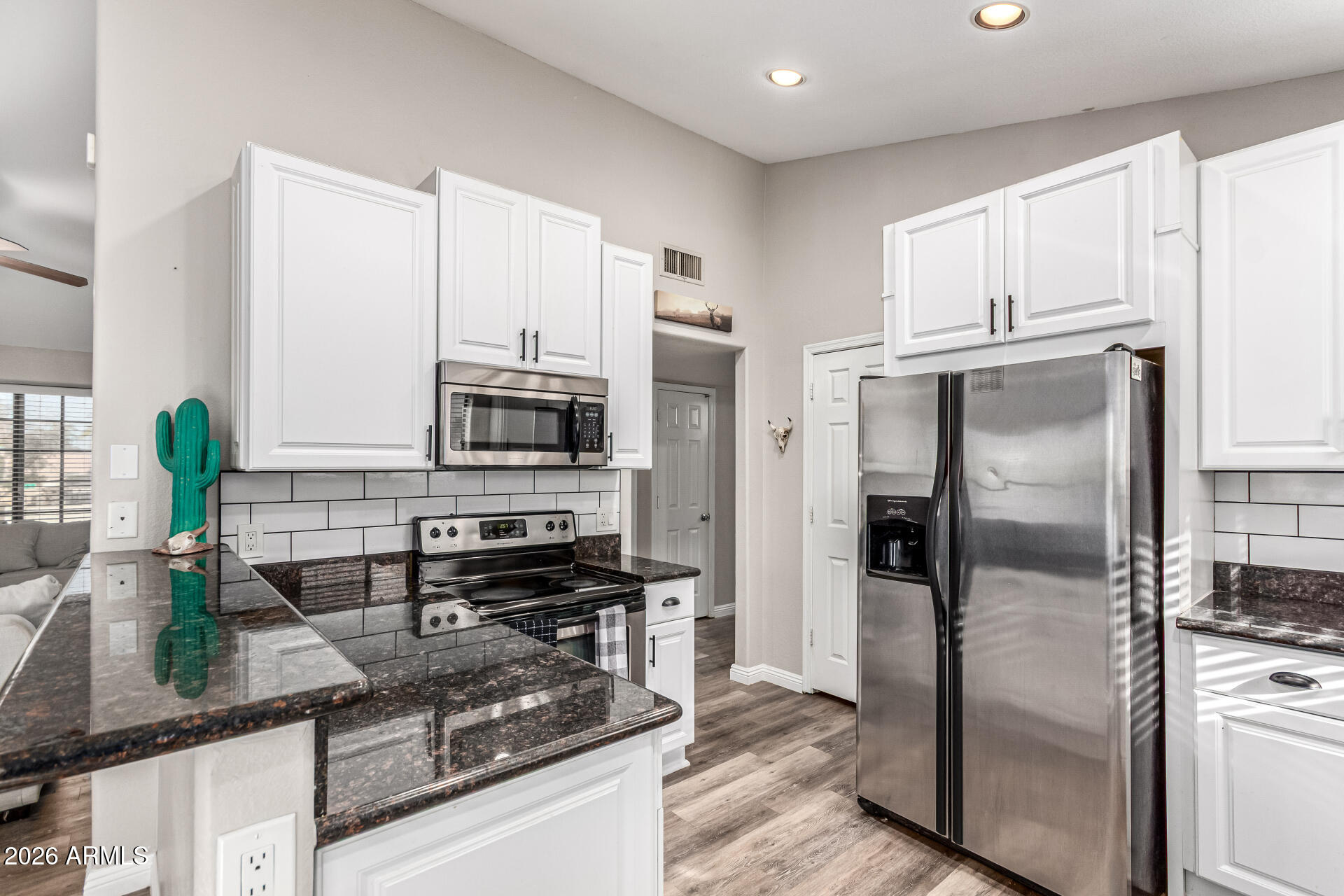 567 West Spur Avenue Gilbert, AZ 85233 - Photo 8 of 42 a kitchen with stainless steel appliances granite countertop a refrigerator and a sink