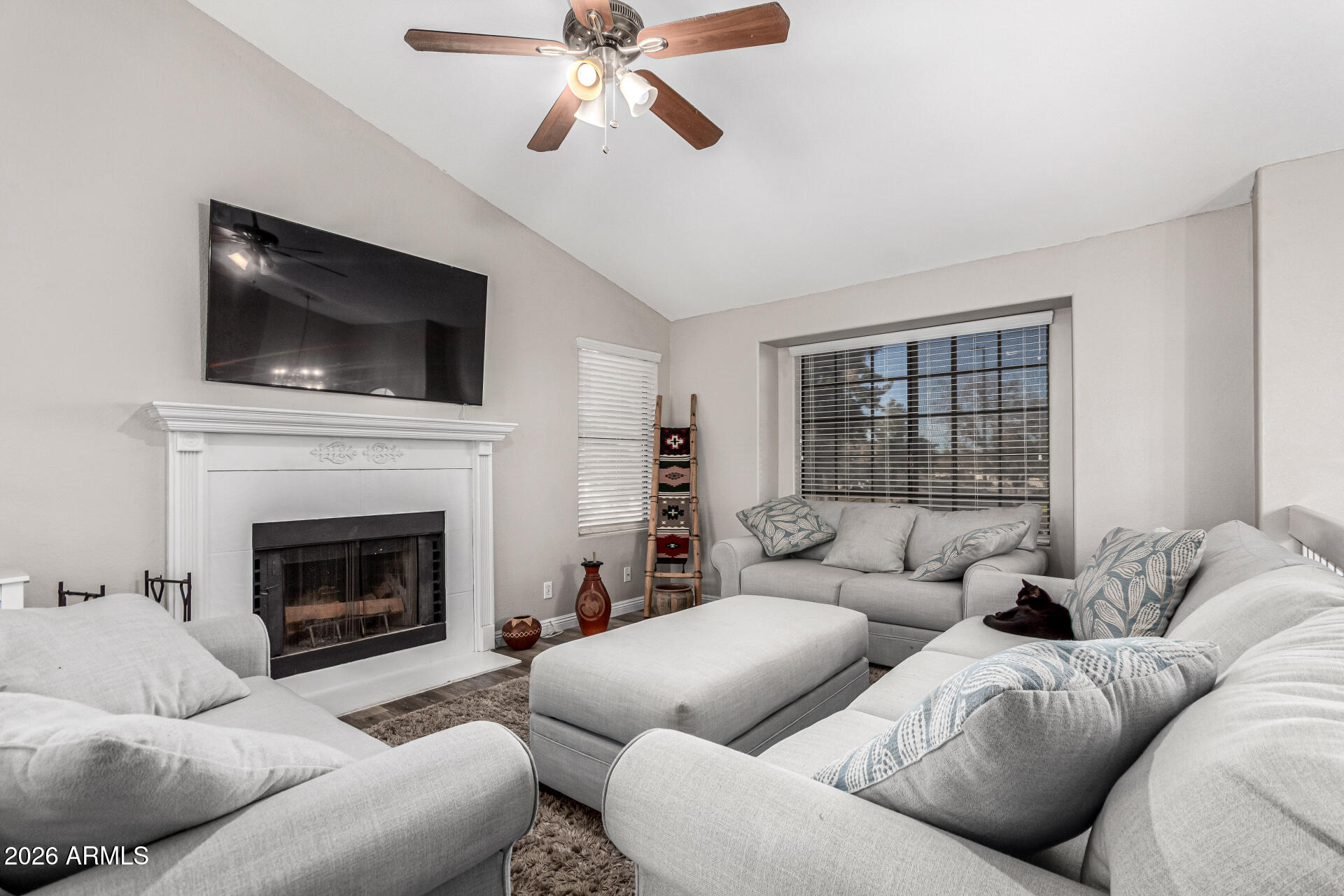 567 West Spur Avenue Gilbert, AZ 85233 - Photo 3 of 42 a living room with furniture a flat screen tv and a fireplace