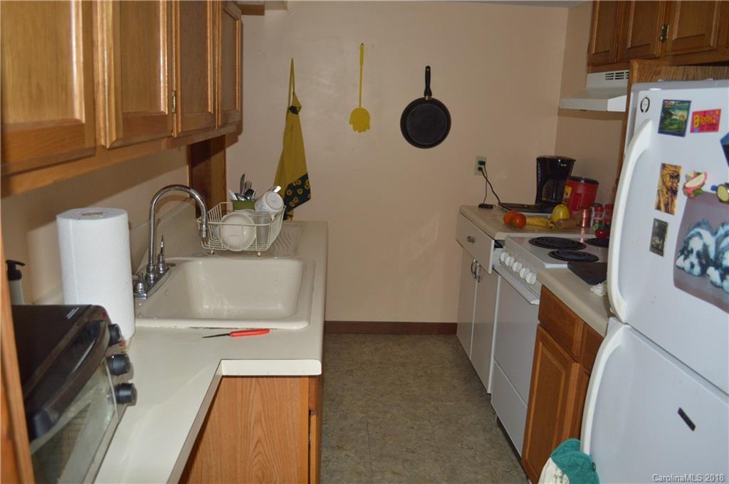 3960 Old Clyde Road Clyde, NC 28721 - Photo 14 of 36 a kitchen with a refrigerator a stove top oven a sink and dishwasher