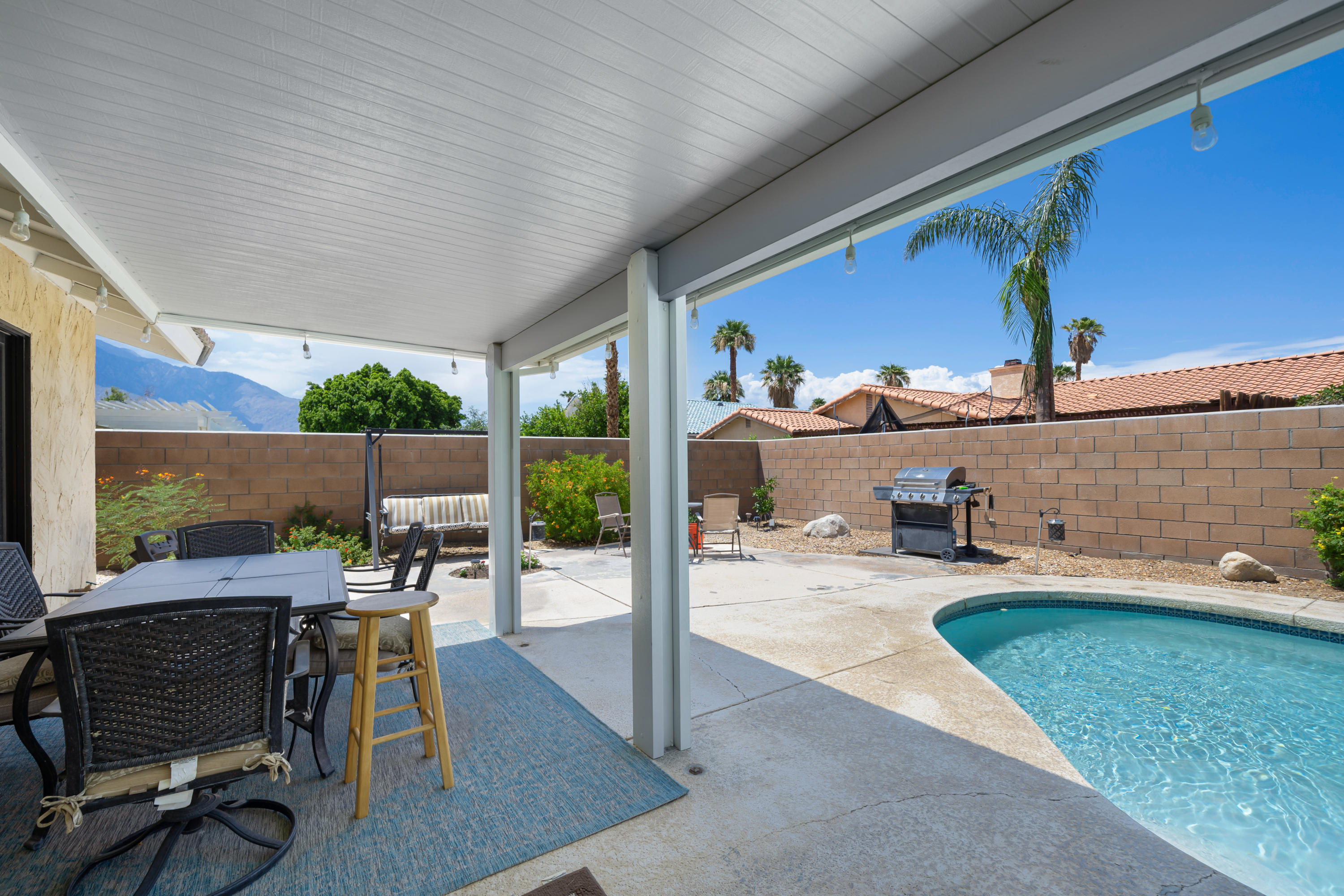 67350 Rango Road Cathedral City, CA 92234 - Photo 22 of 30 a view of a patio with table and chairs and potted plants