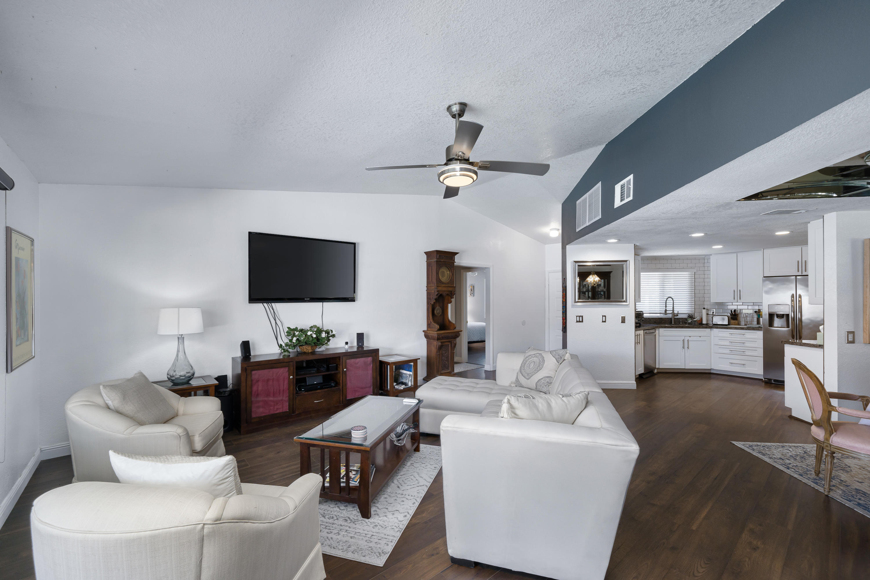 67350 Rango Road Cathedral City, CA 92234 - Photo 5 of 30 a living room with furniture a flat screen tv and kitchen view
