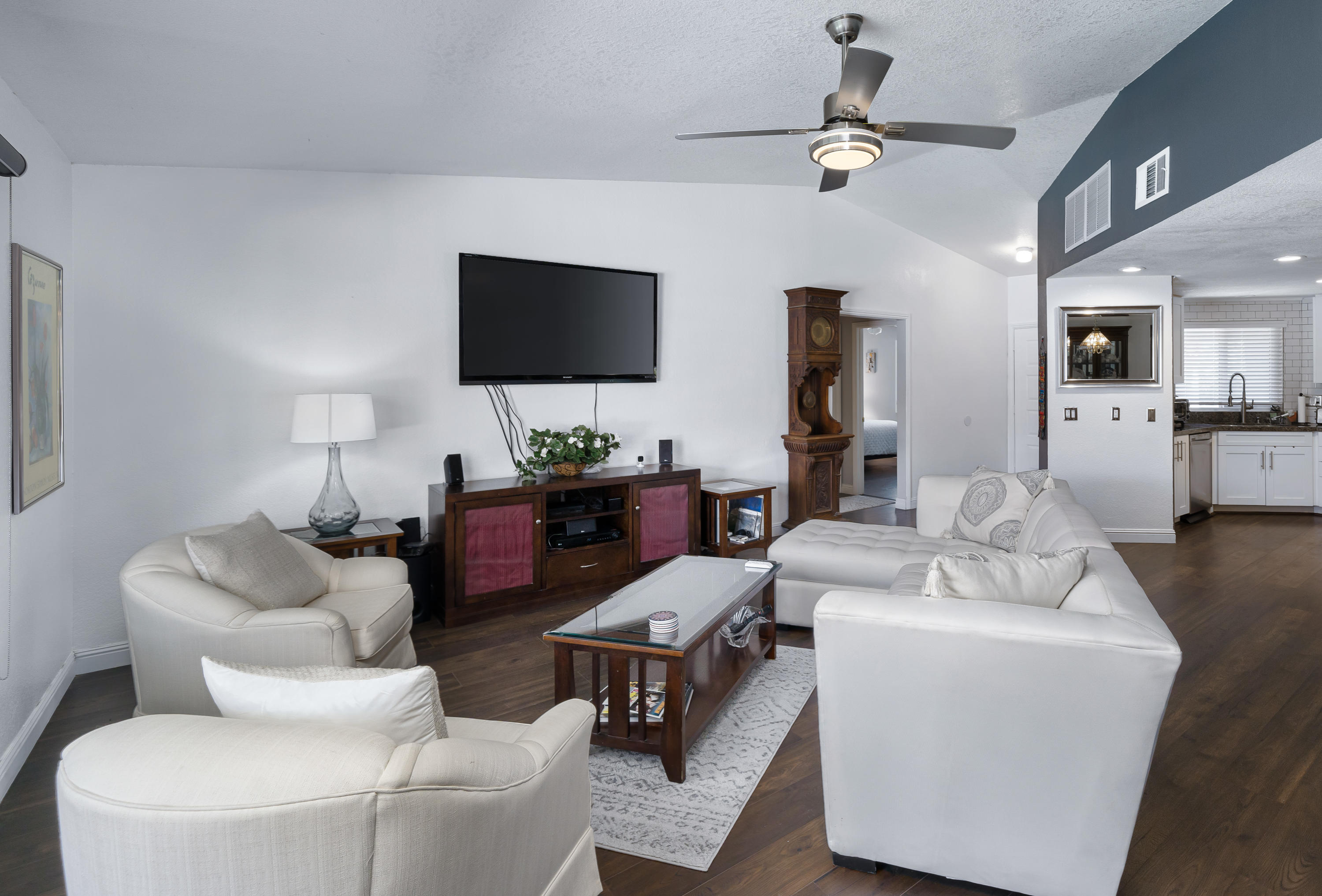 67350 Rango Road Cathedral City, CA 92234 - Photo 8 of 30 a living room with furniture a flat screen tv and a chandelier