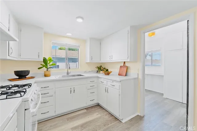a kitchen with white cabinets and a sink