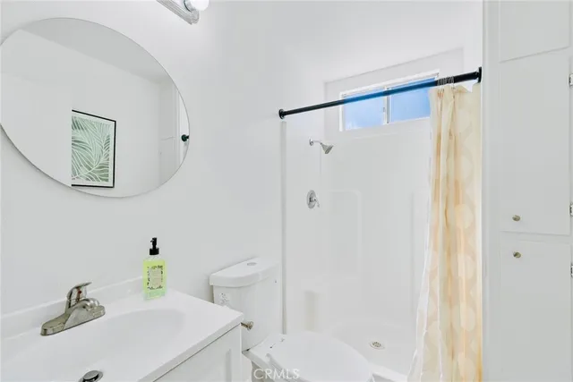 a bathroom with a shower and a sink