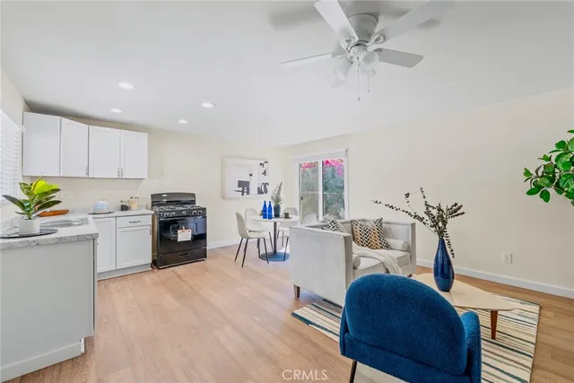 a living room with furniture a fireplace and a potted plant