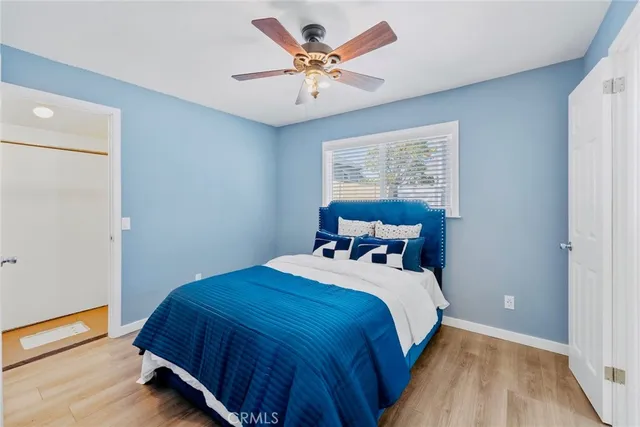 a bedroom with a bed and a ceiling fan