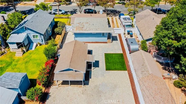 an aerial view of a house with a yard and pool