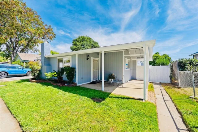 a view of a house with a yard patio and swimming pool