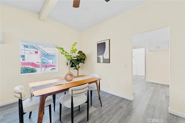 a dining room with furniture and wooden floor