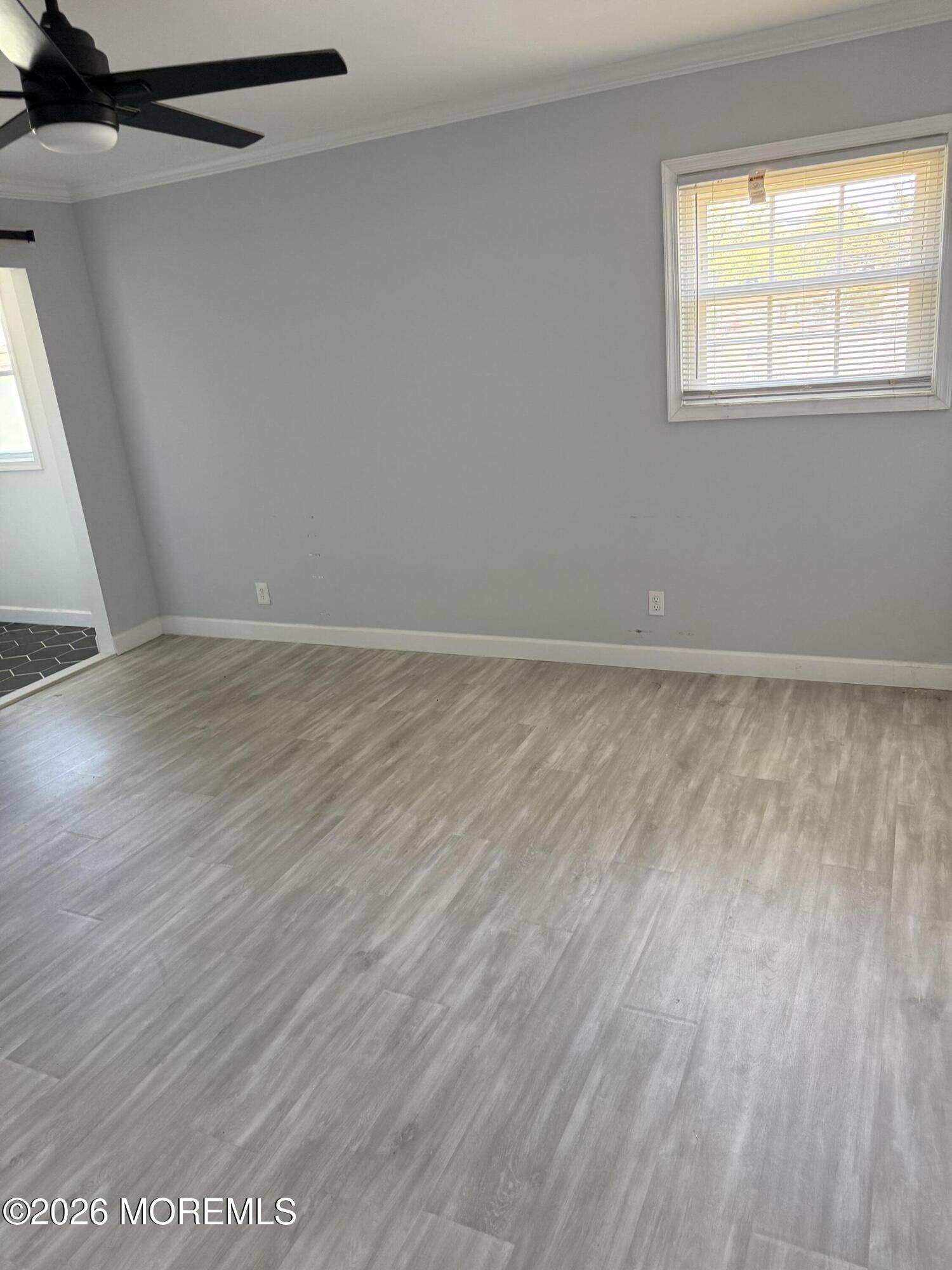 3 Lake Drive Howell, NJ 07731 - Photo 15 of 18 a view of an empty room with wooden floor and a window
