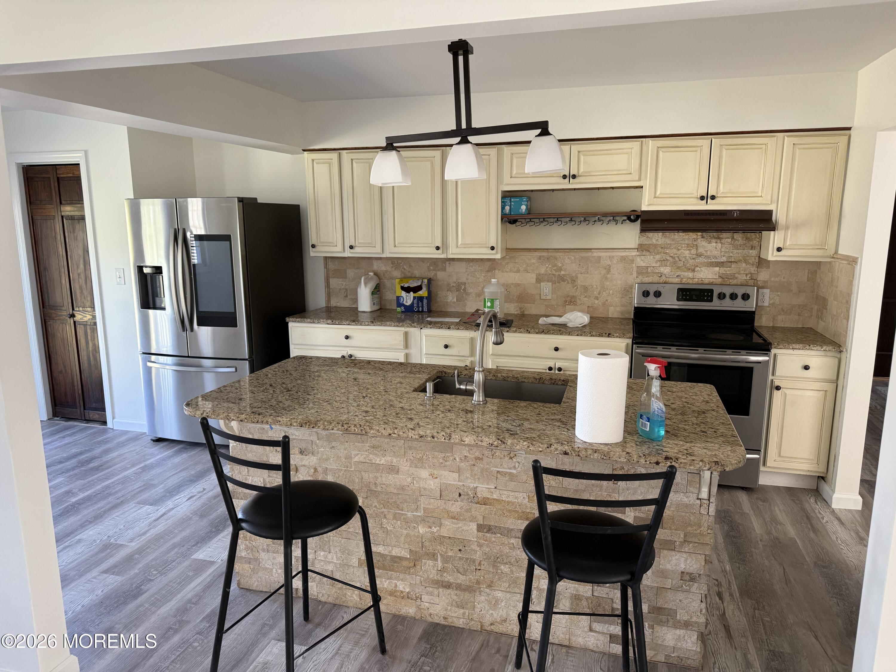 3 Lake Drive Howell, NJ 07731 - Photo 7 of 18 a kitchen with stainless steel appliances kitchen island granite countertop a refrigerator and stove