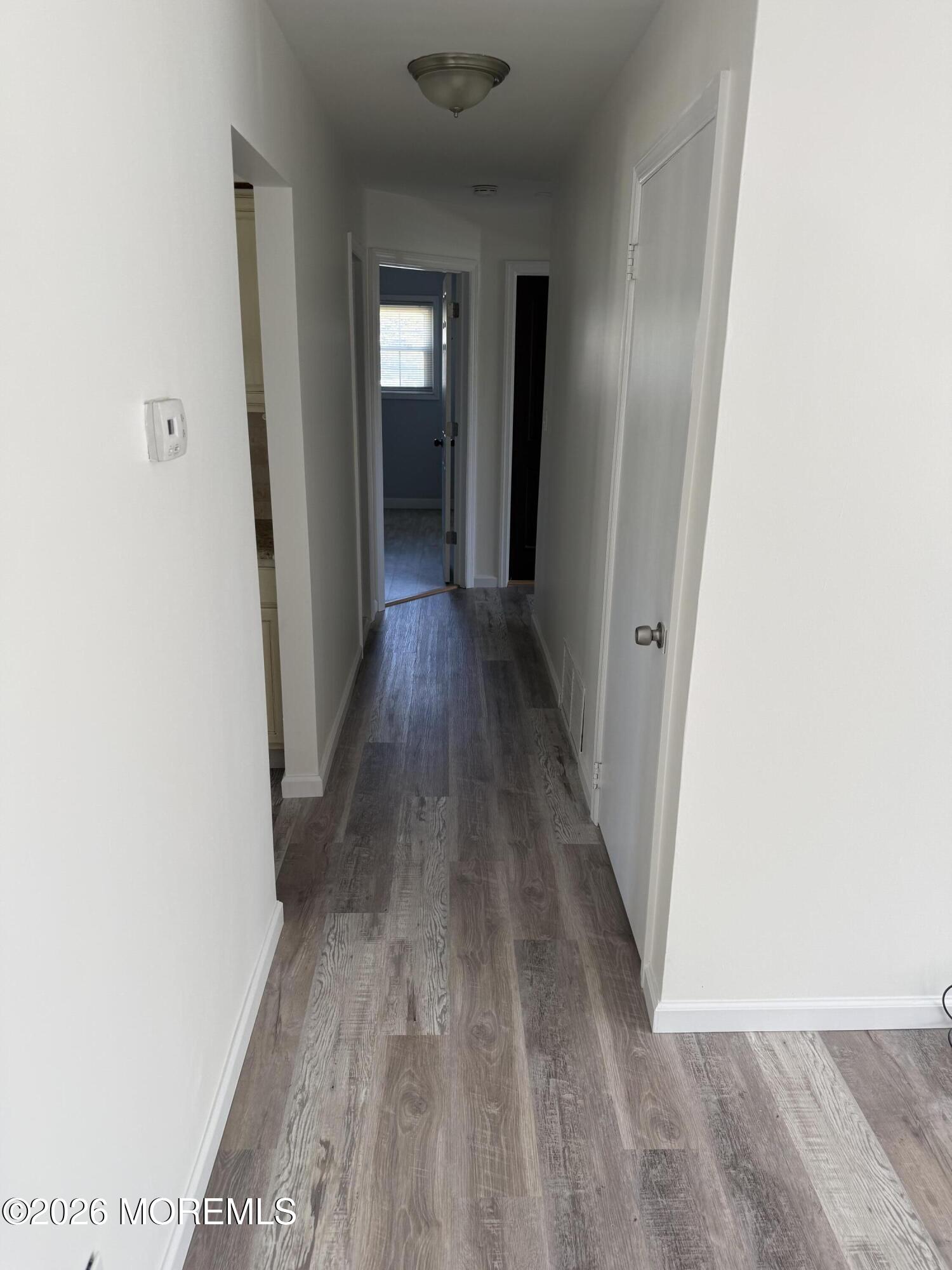 3 Lake Drive Howell, NJ 07731 - Photo 8 of 18 a view of a hallway with wooden floor