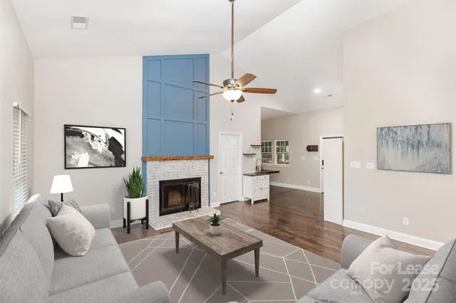 a living room with furniture and a fireplace