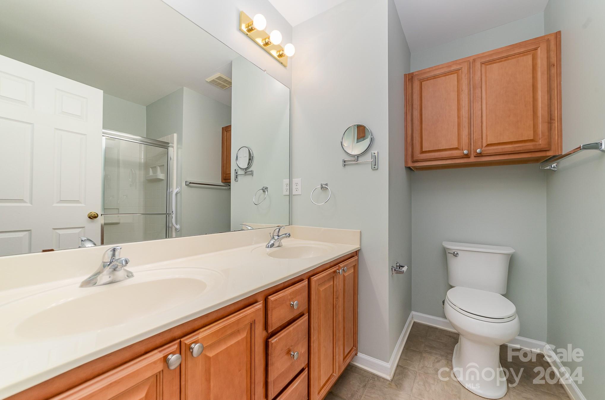 11546 Rabbit Ridge Road Charlotte, NC 28270 - Photo 11 of 17 a bathroom with a sink a toilet and mirror