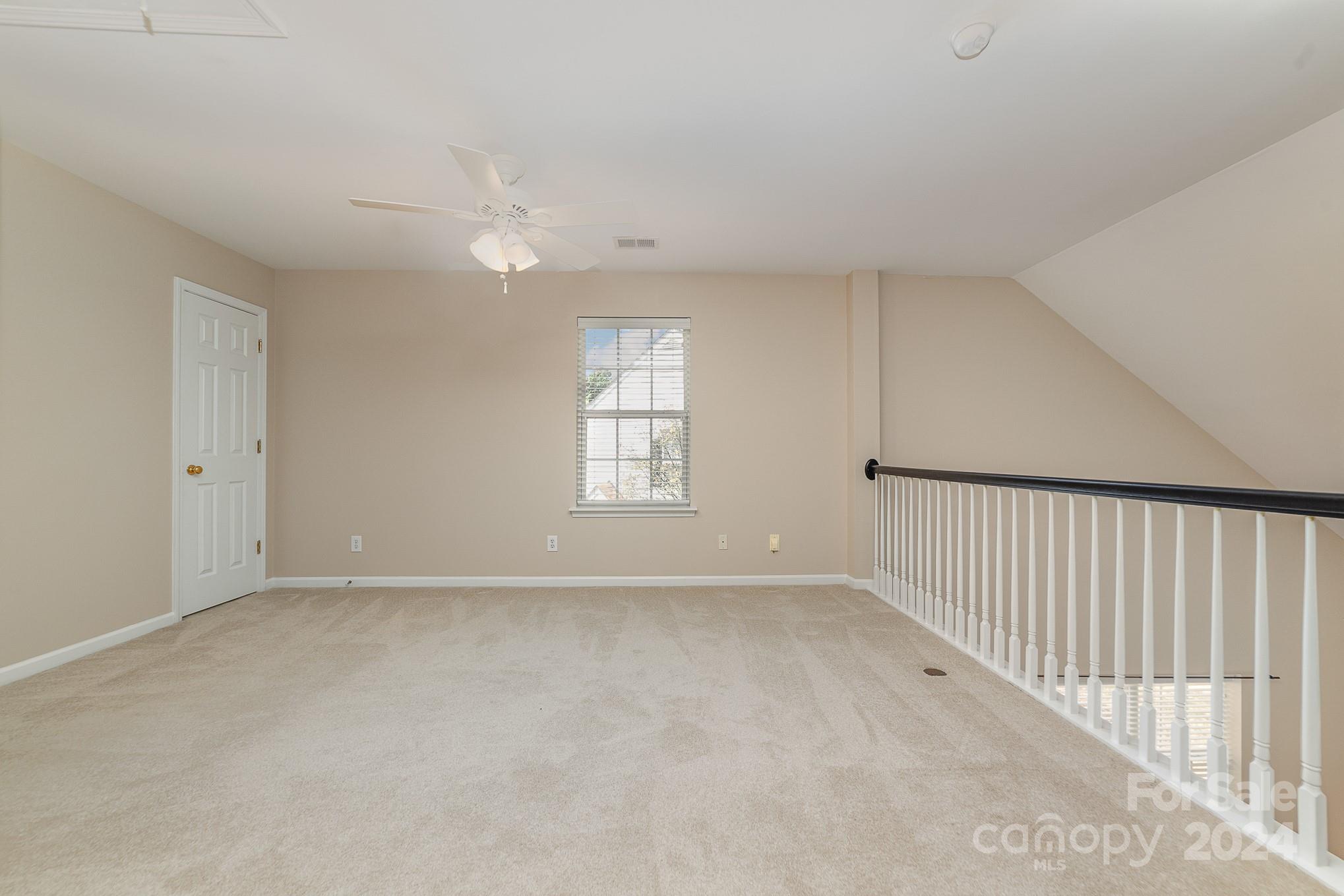 11546 Rabbit Ridge Road Charlotte, NC 28270 - Photo 13 of 17 wooden floor in an empty room with a window