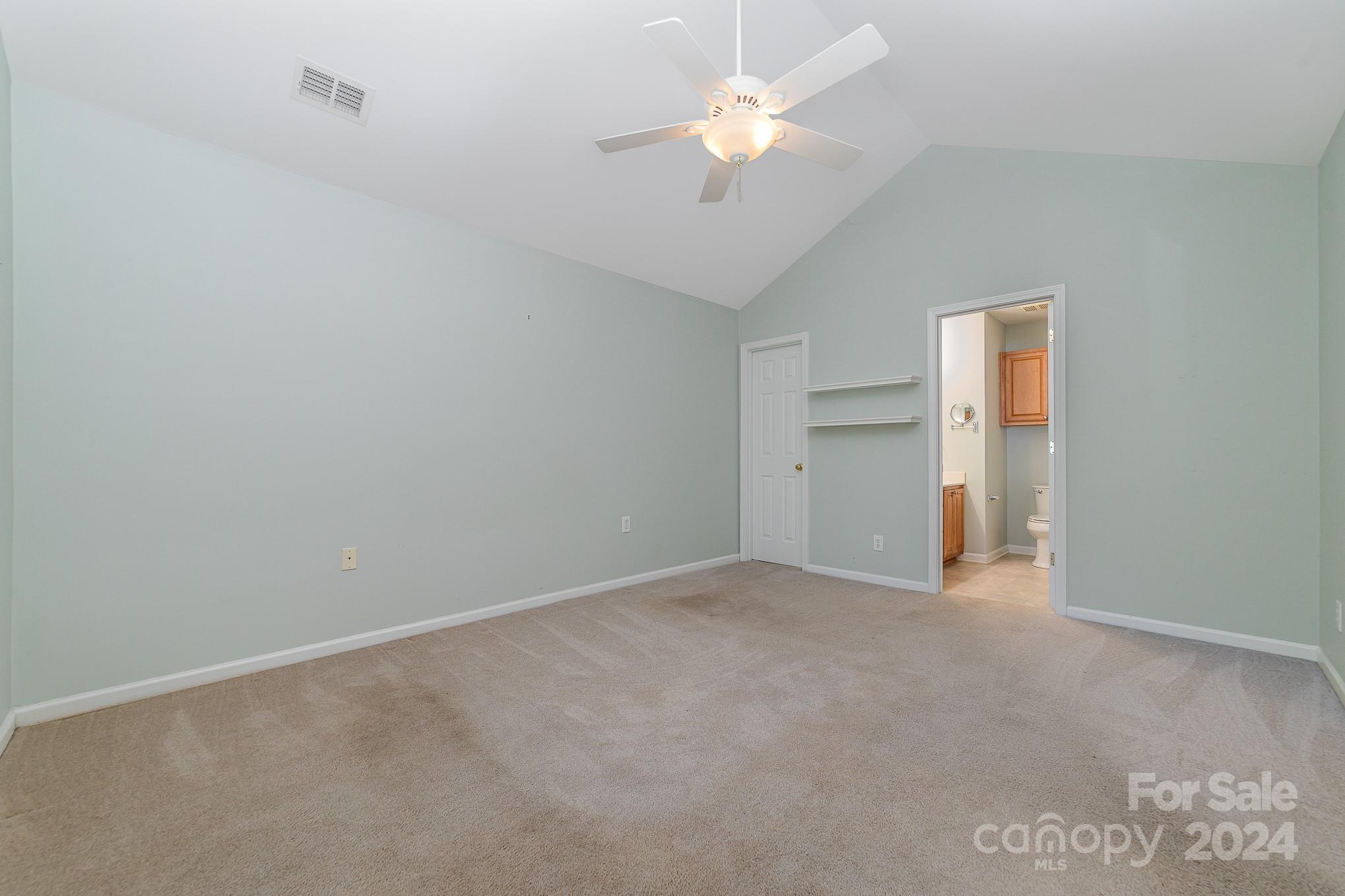 11546 Rabbit Ridge Road Charlotte, NC 28270 - Photo 14 of 17 an empty room with a ceiling fan and a window