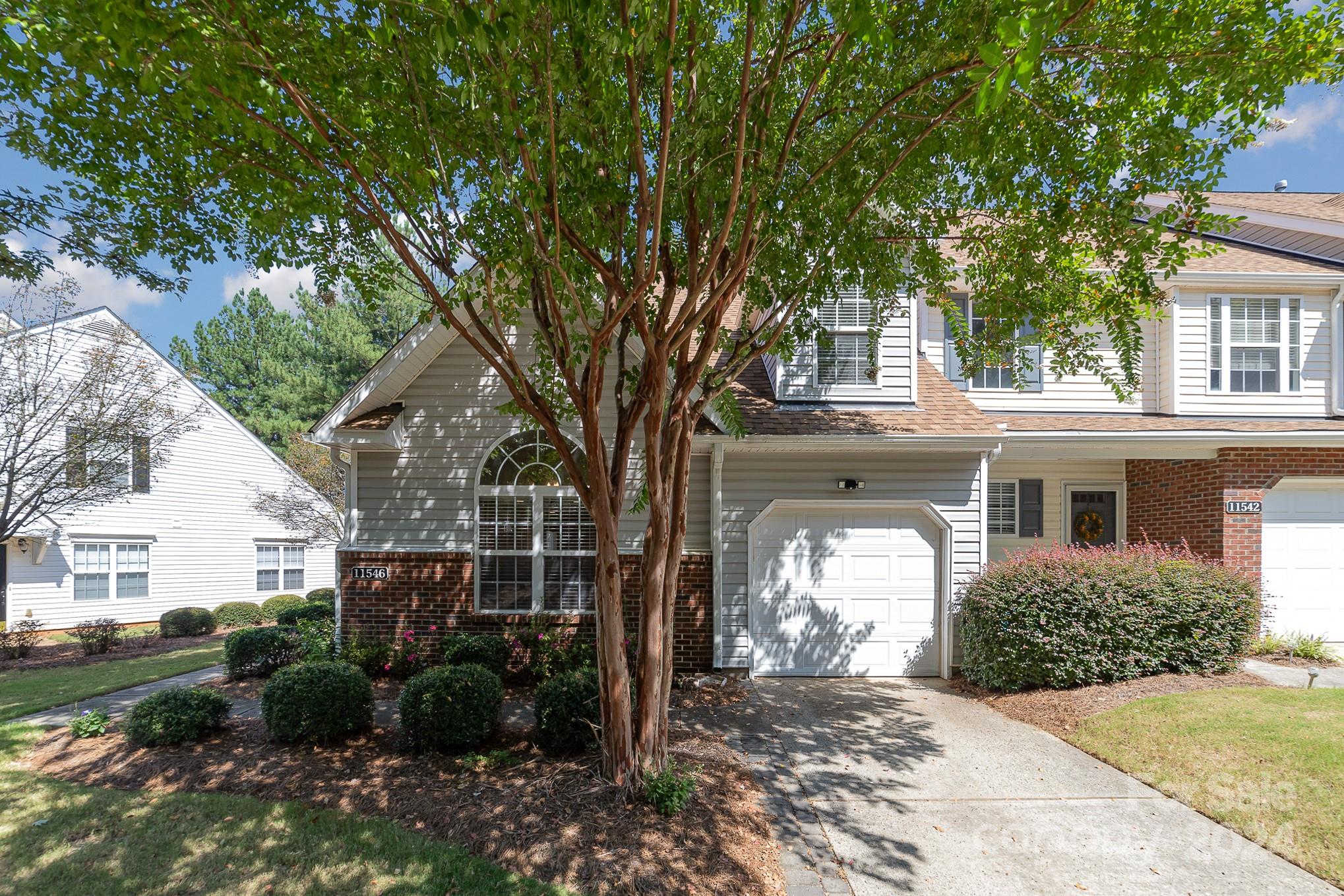 11546 Rabbit Ridge Road Charlotte, NC 28270 - Photo 2 of 17 a front view of a house with a garden